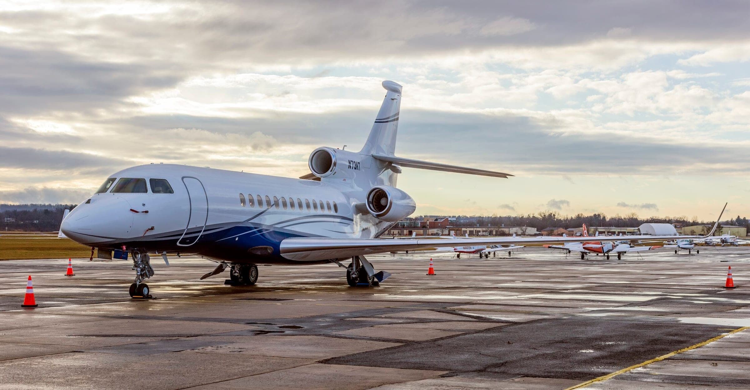Dassault Falcon 7X N73KT on ground at airport after rain storm