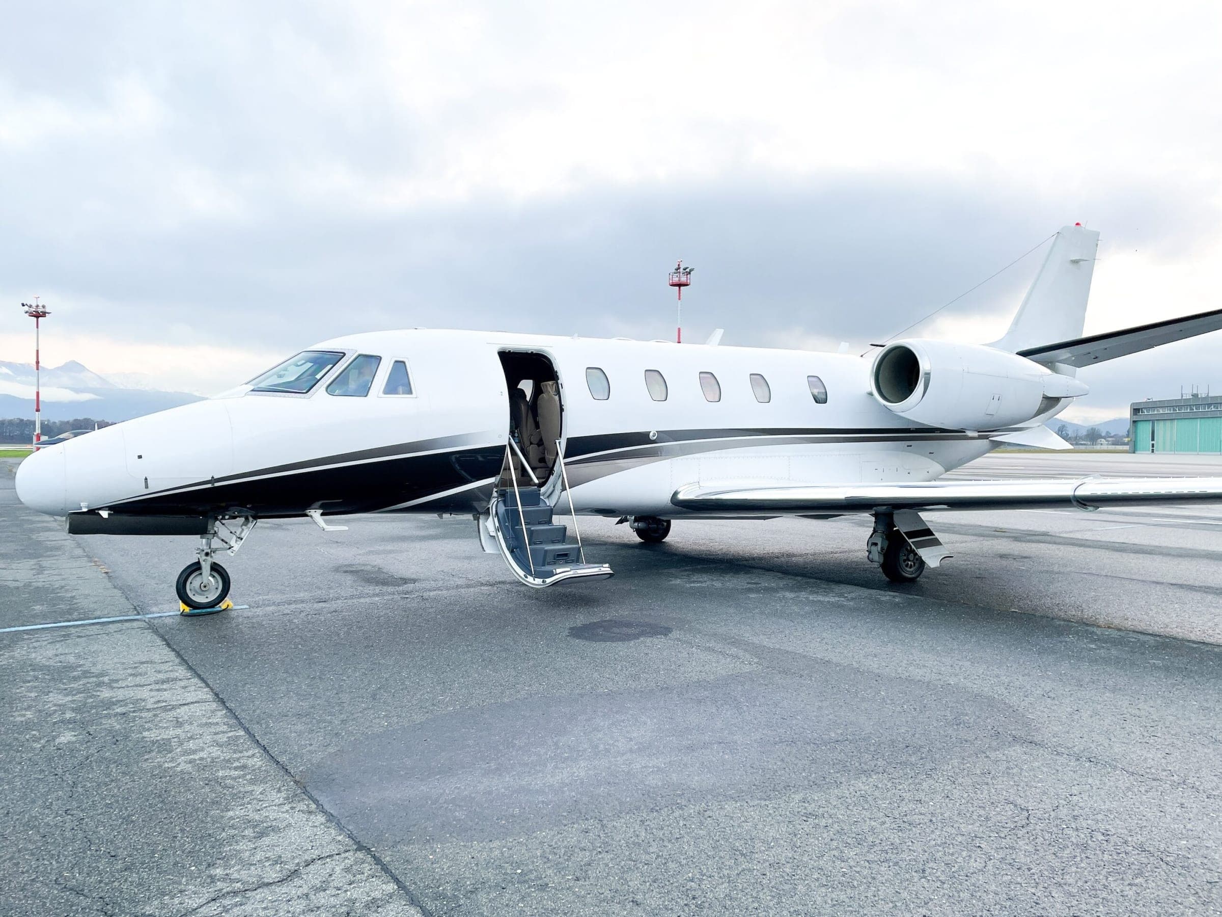 Cessna Citation at airport parking stand with door open ready for departure