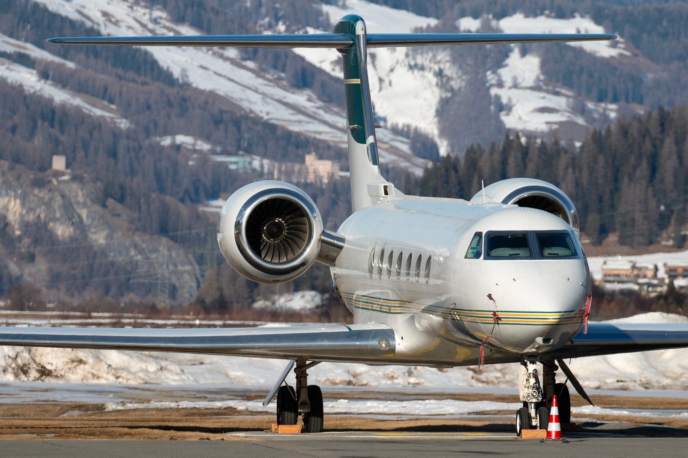 Gulfstream private jet with green tail front on view parked at Samedan airport in Switzerland