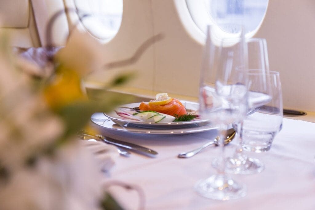 Salmon meal on private jet close up, travel by private jet