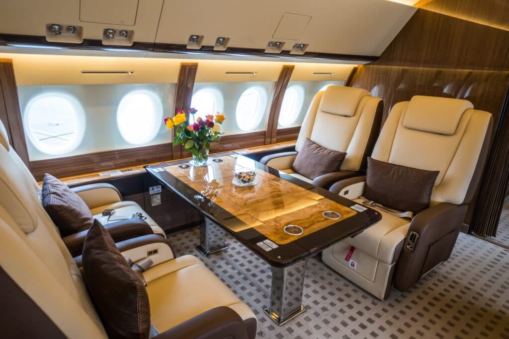 Luxury interior in the modern private business jet looking at dining table