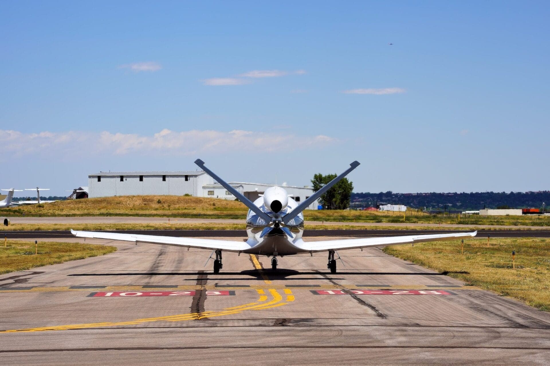 Rear view of Cirrus SF50 vision jet taxiing at airport