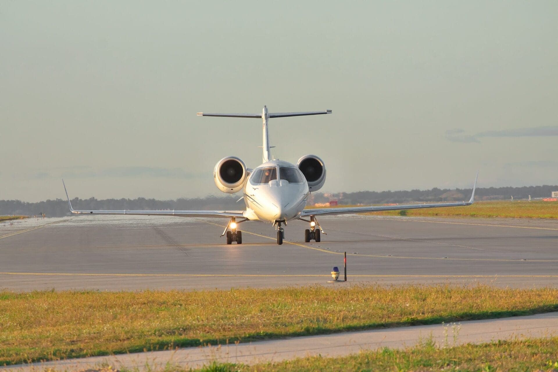 Business jet taxiing along the runway front on