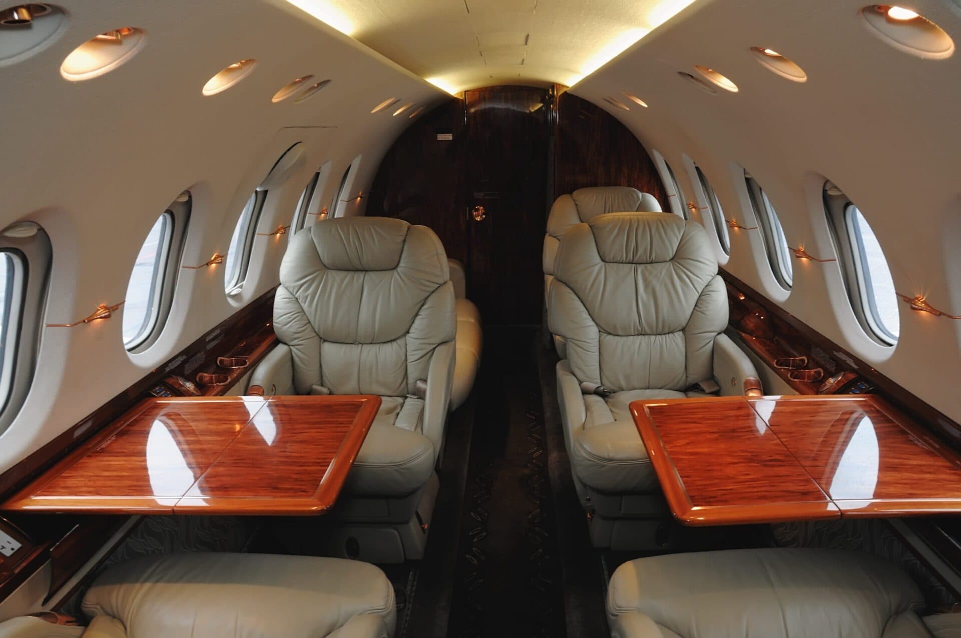 interior of midsize business jet with tables extended