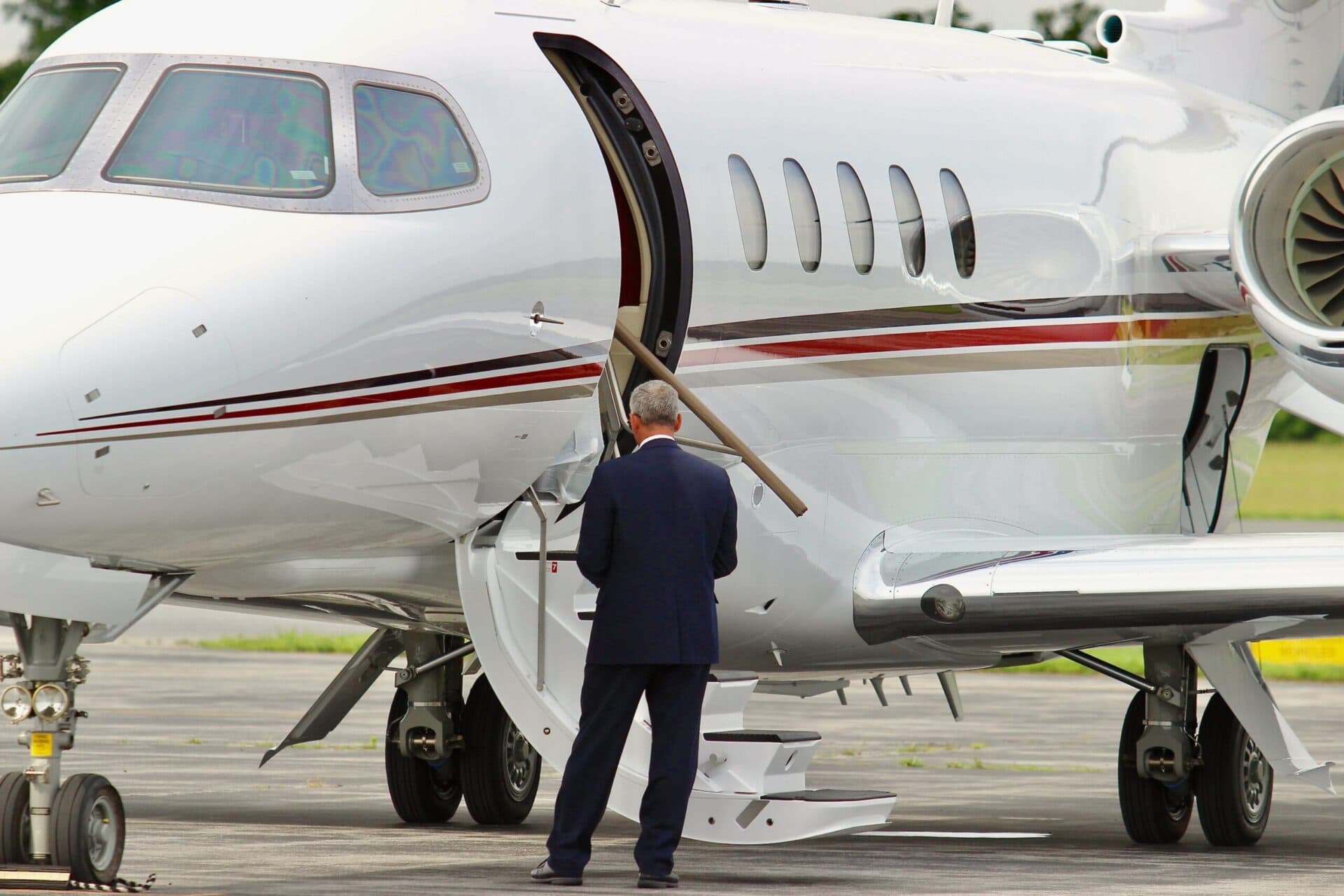 Businessman next to his corporate jet.