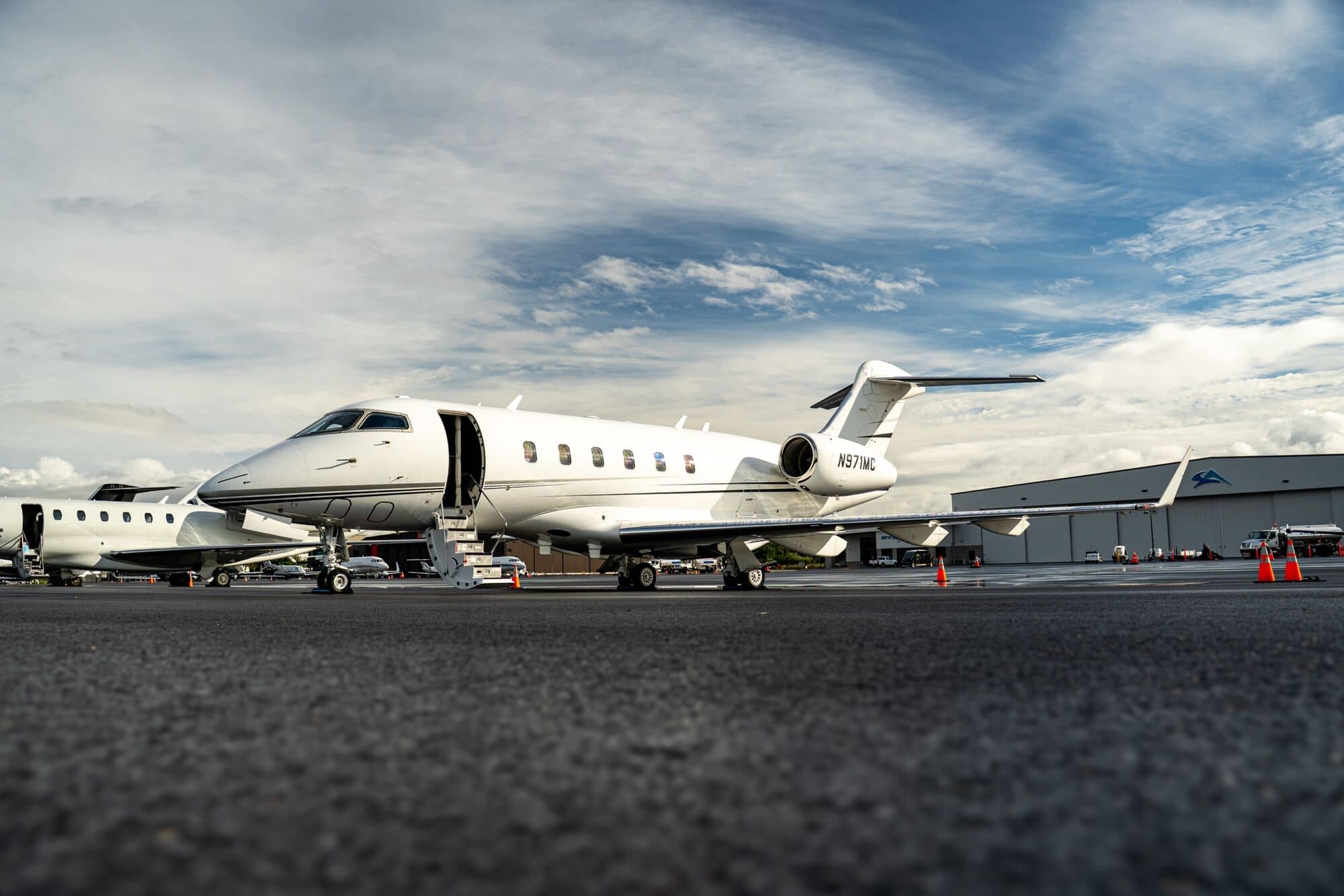 CRAFT Challenger 300 N971MC on the ramp under a cloudy sky