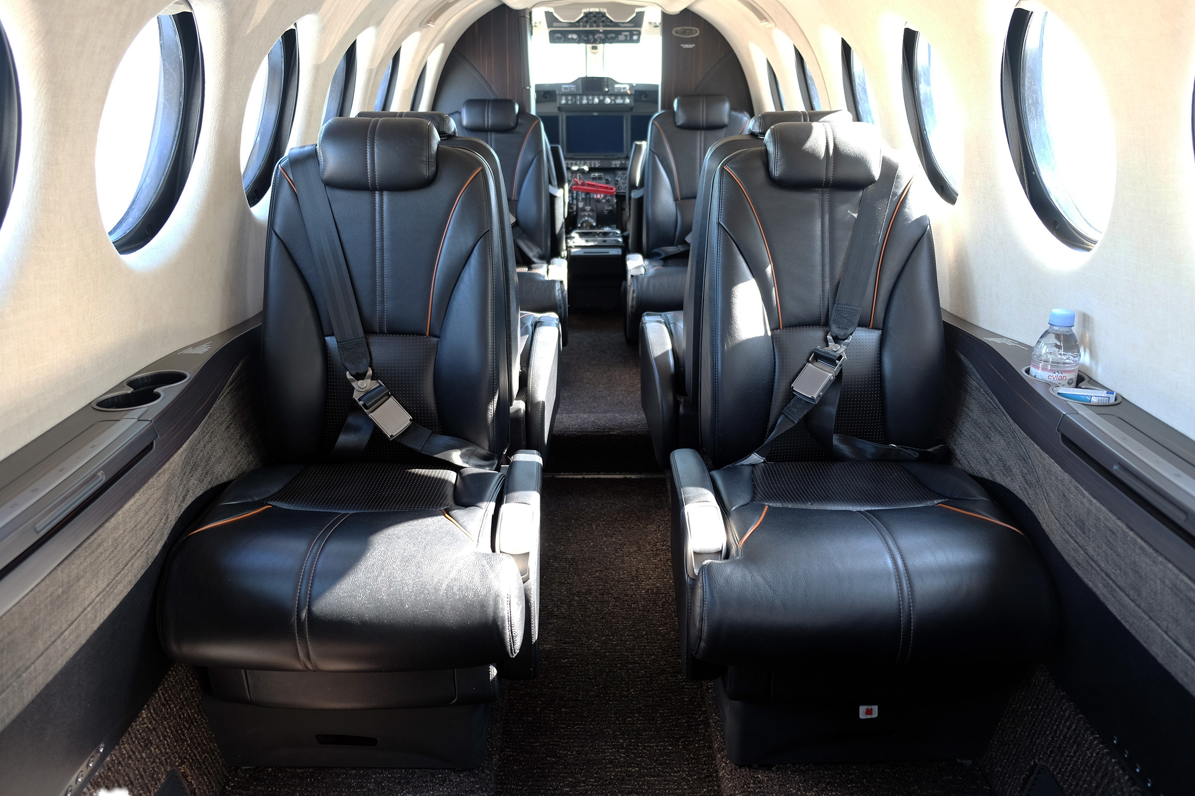 Beechcraft King Air 360 interior with black leather seats from the aft of the cabin looking forward towards the cockpit