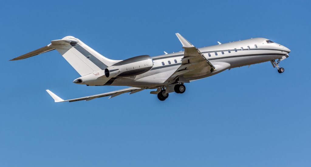 Bombardier Global 6000 taking off from airport while wheels retract