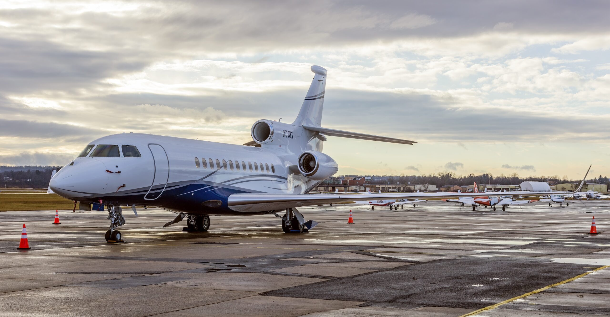Dassault Falcon 7X N73KT on ground at airport after rain storm