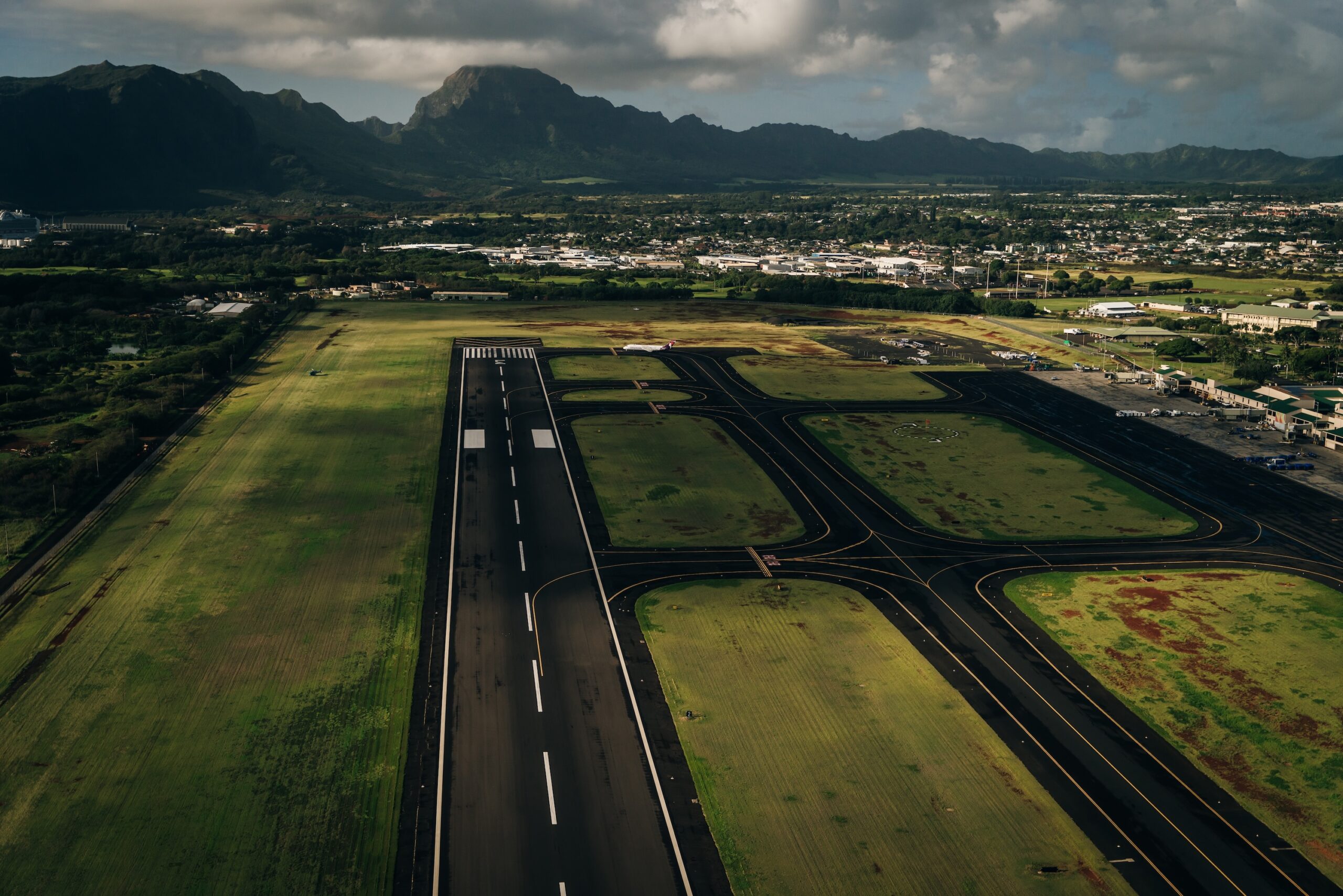 Aerial view of the runway and plane hangars of Lihue airport on Kauai island, Hawaii, United States
