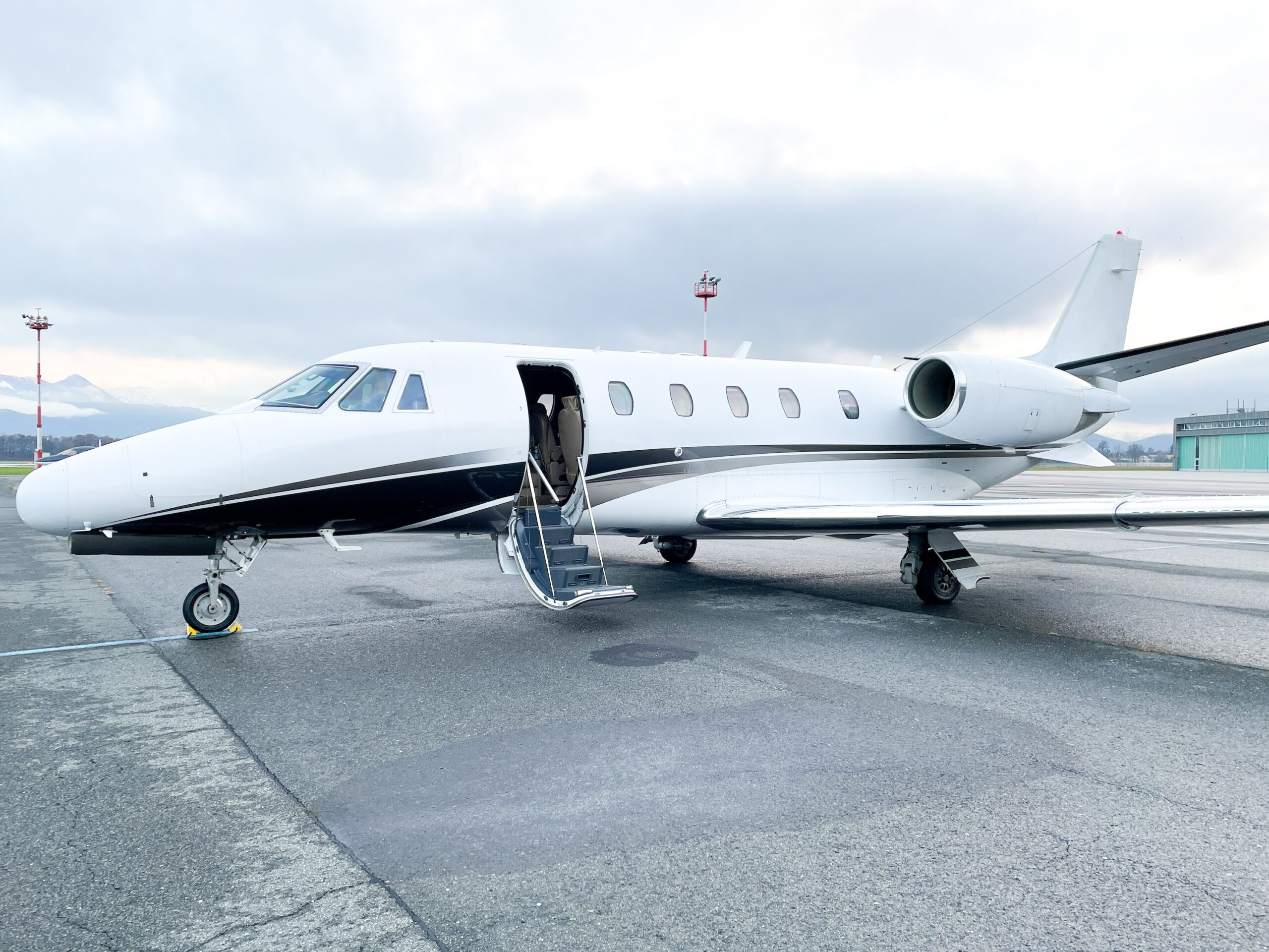 Cessna Citation at airport parking stand with door open ready for departure