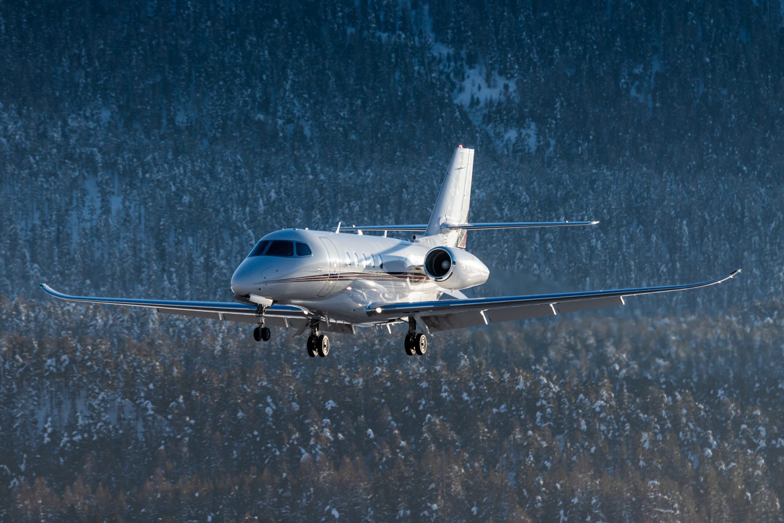 Cessna Citation Latitude exterior on approach to land at Engadin airport in the Swiss alps