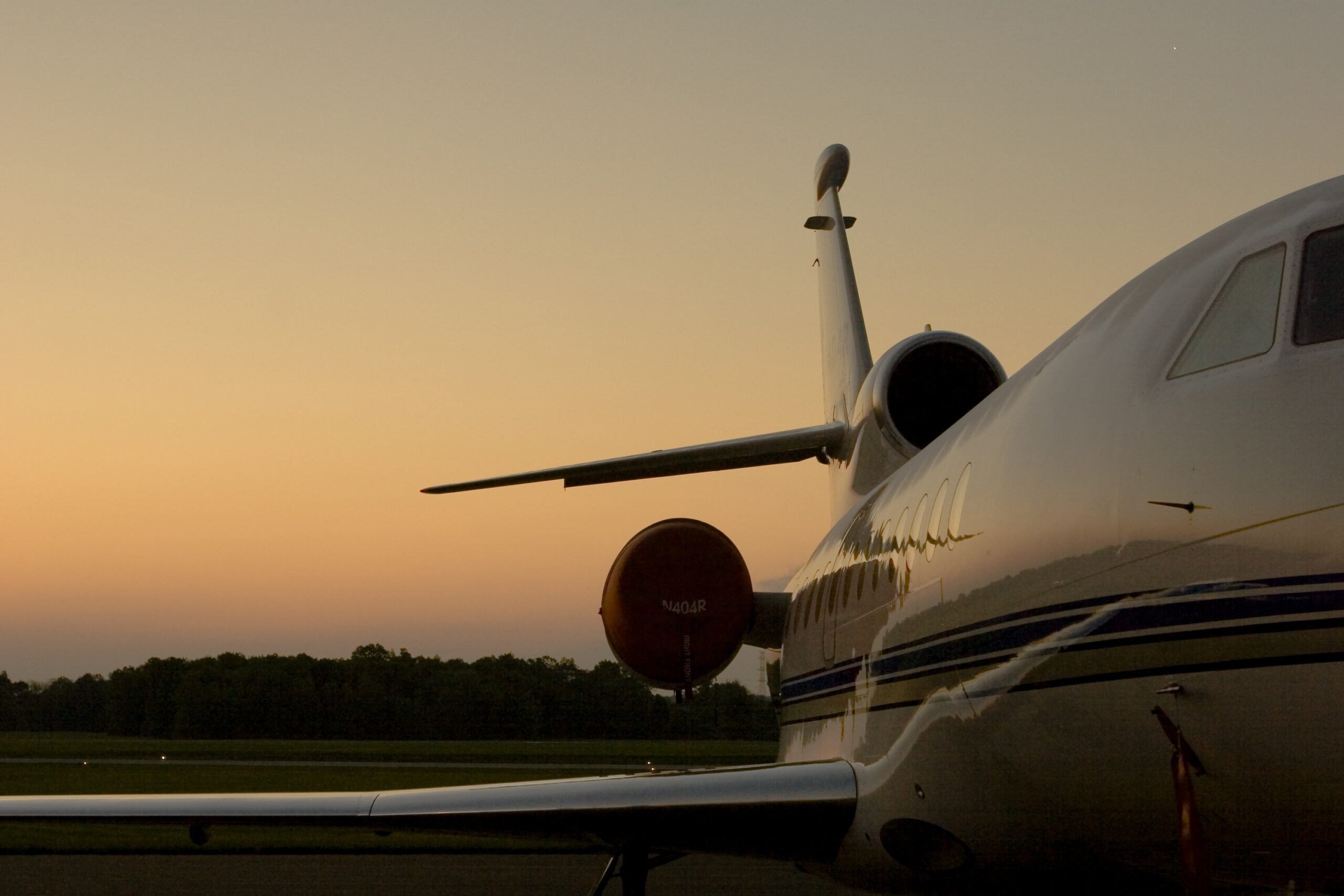 Rear view of engines of Dassault Falcon three engine jet during sunset