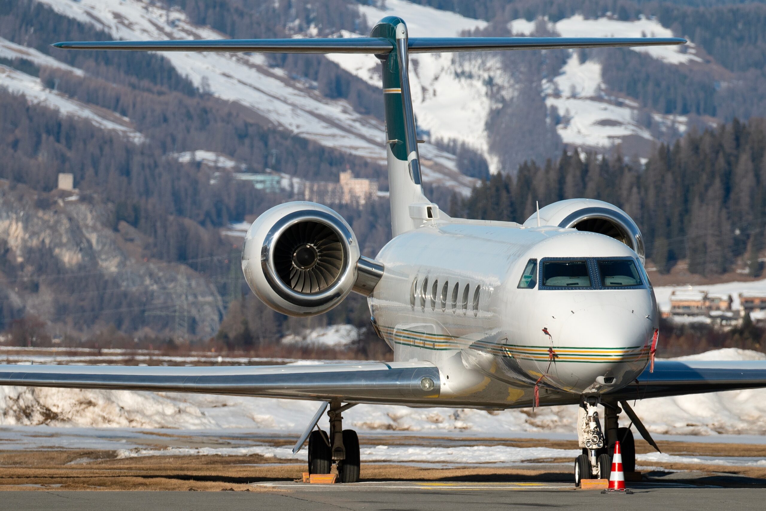 Gulfstream private jet with green tail front on view parked at Samedan airport in Switzerland