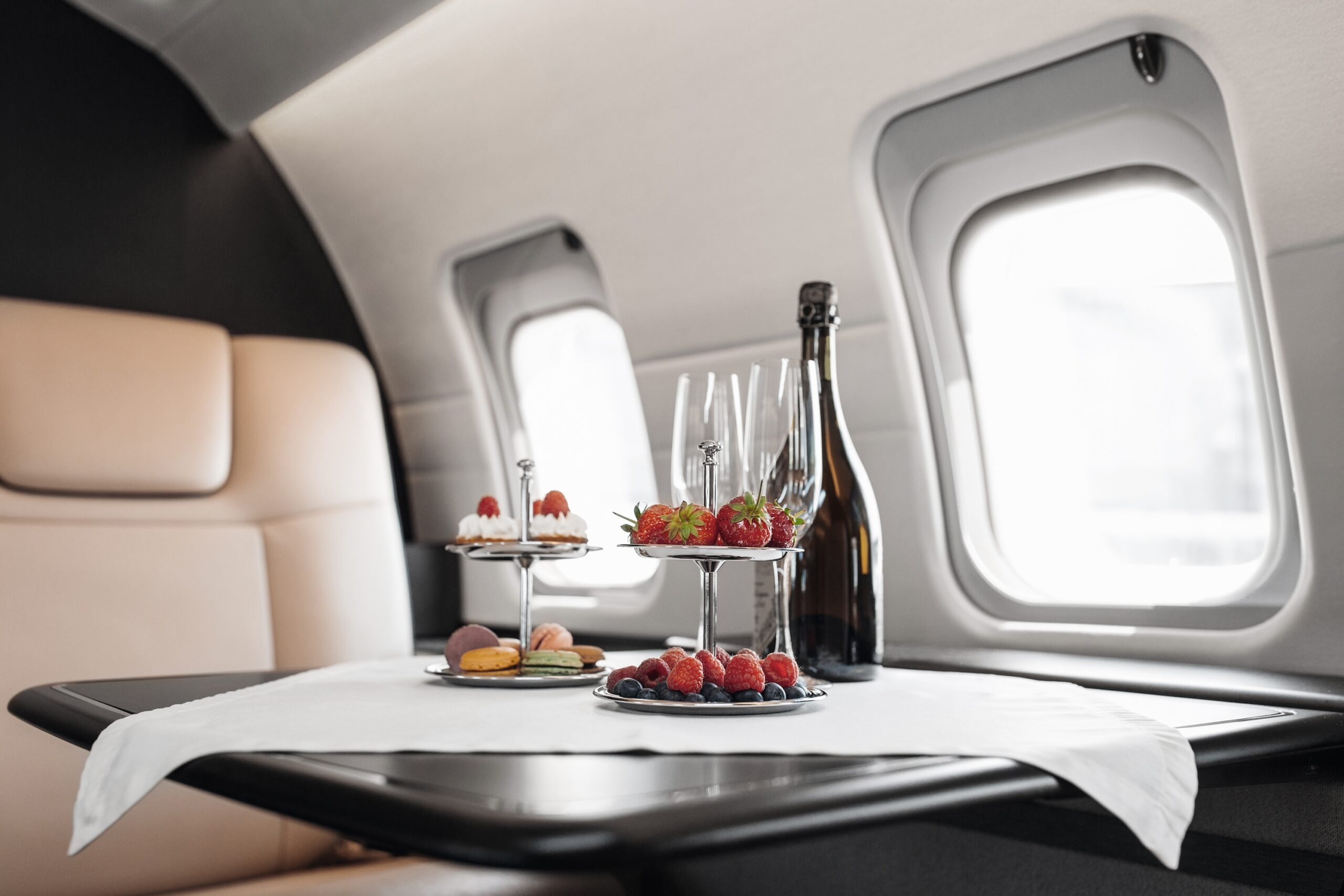Private jet catering interior with strawberries and champagne