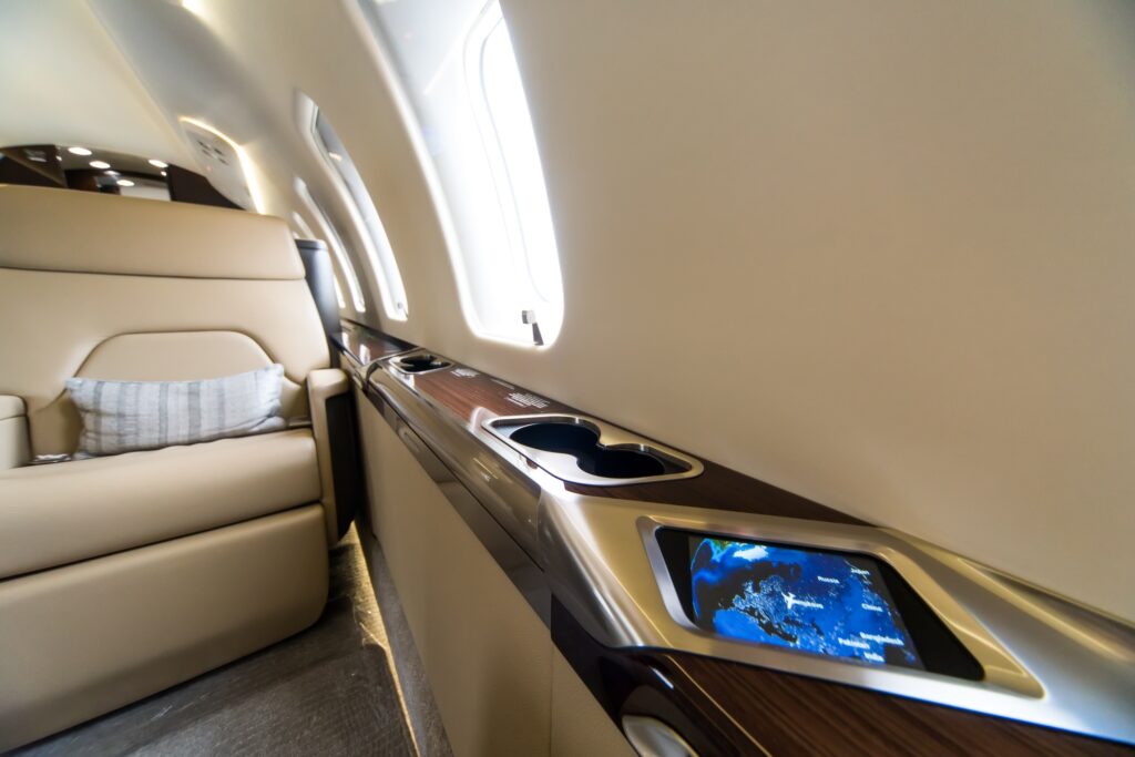 Interior or private jet with close up of mini display and moving map