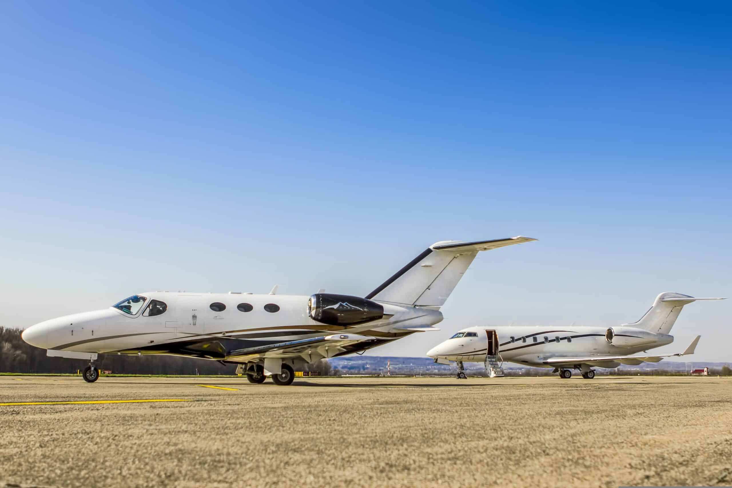 Cessna Citation Mustang on ground at airport with another private jet behind