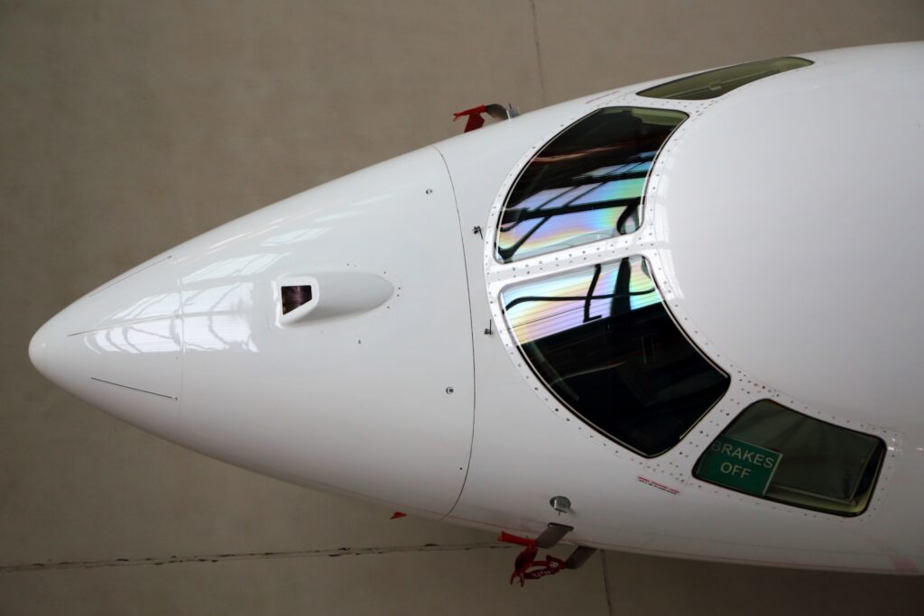 Top down view of private jet nose and windscreen with camera visible on the nose
