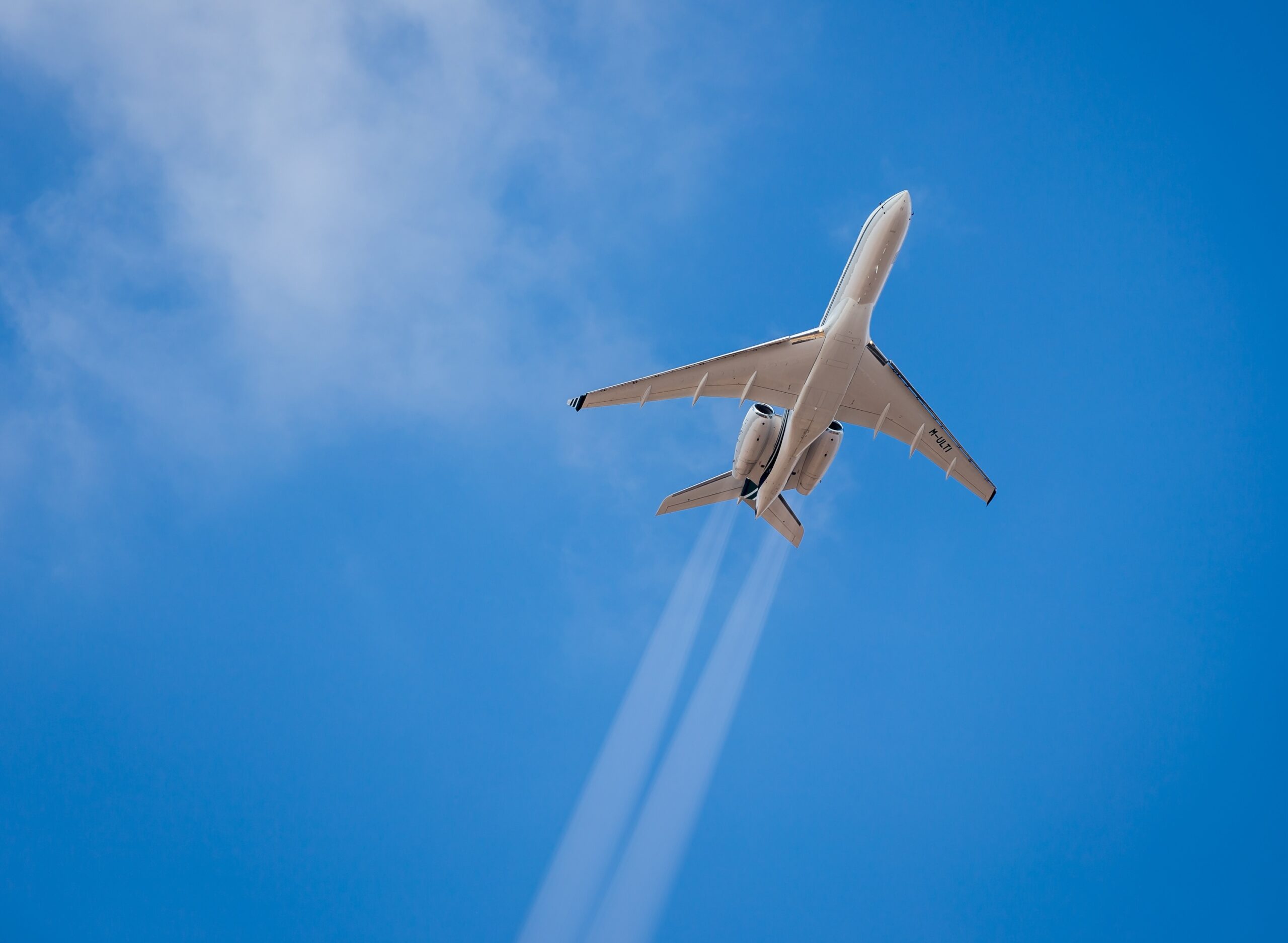 Underside of private jet flying through the air