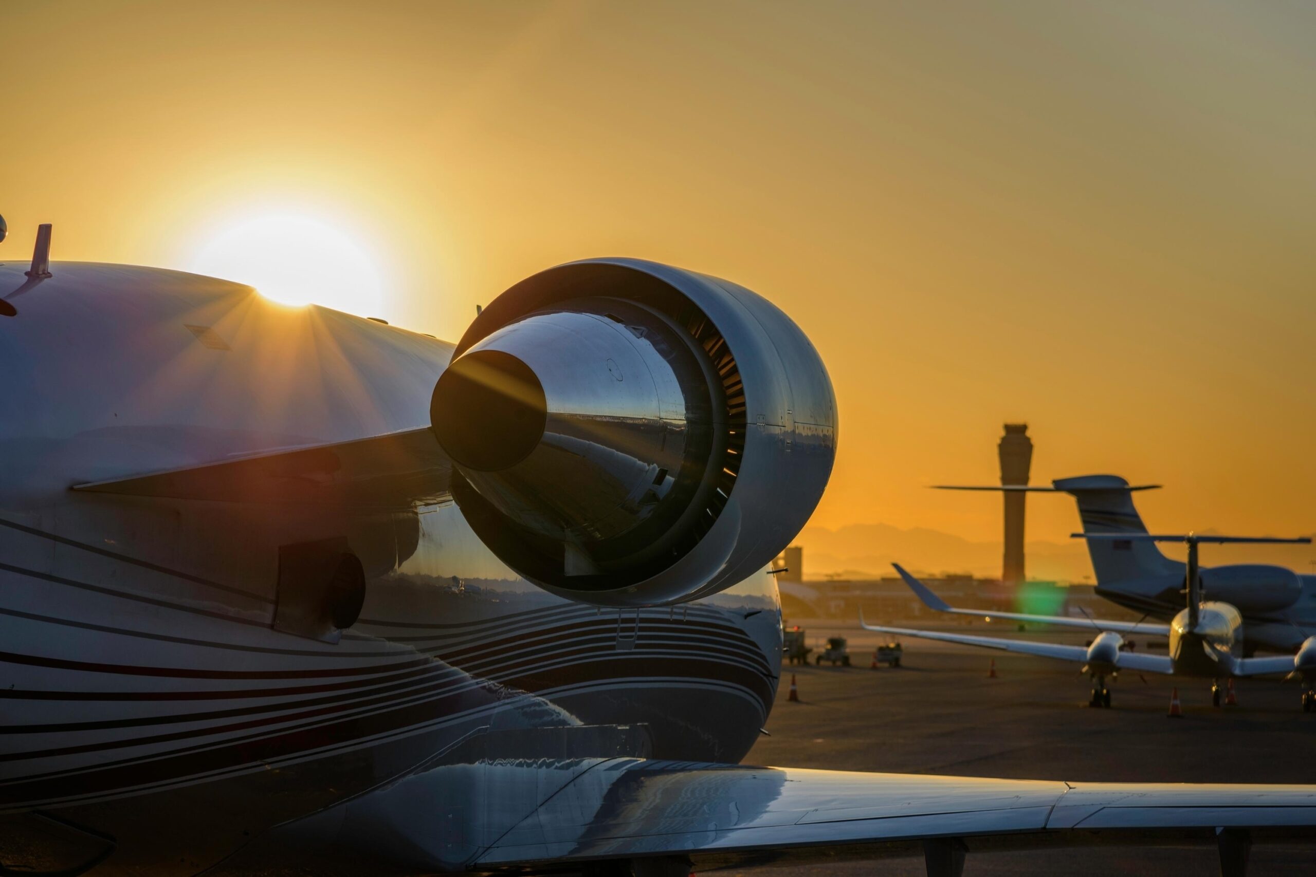 Close up view of back of jet engine looking forward with sun and golden sky behind