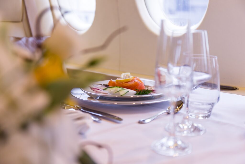 Salmon meal on private jet close up, travel by private jet