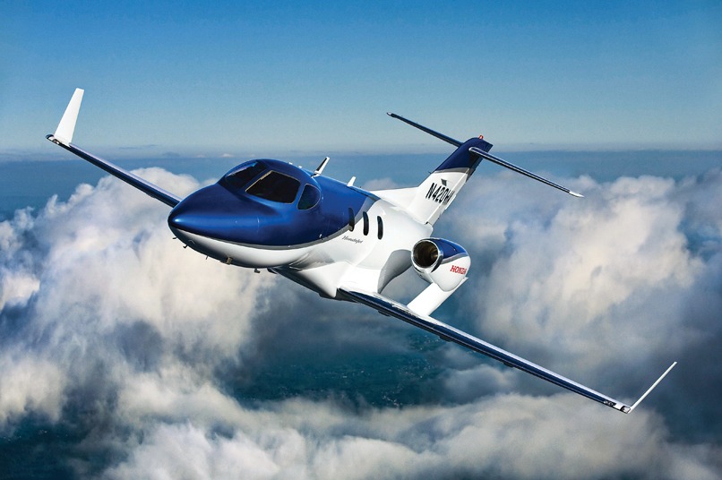 HondaJet Exterior in blue paint, aerial shot above the clouds banking left