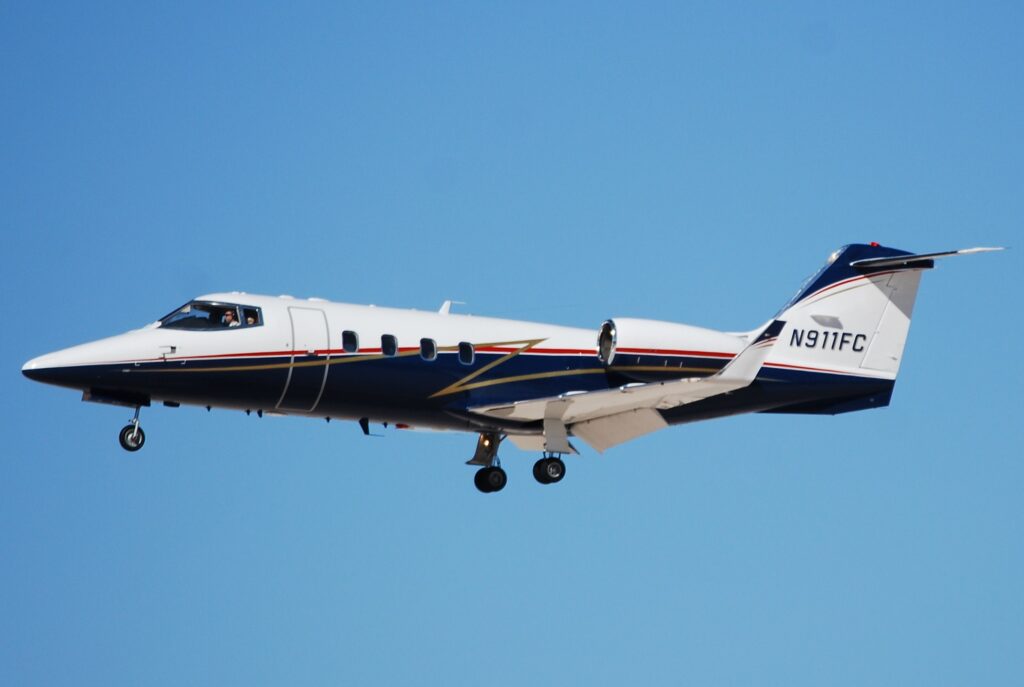 Bombardier Learjet 55 exterior on approach to land with blue sky