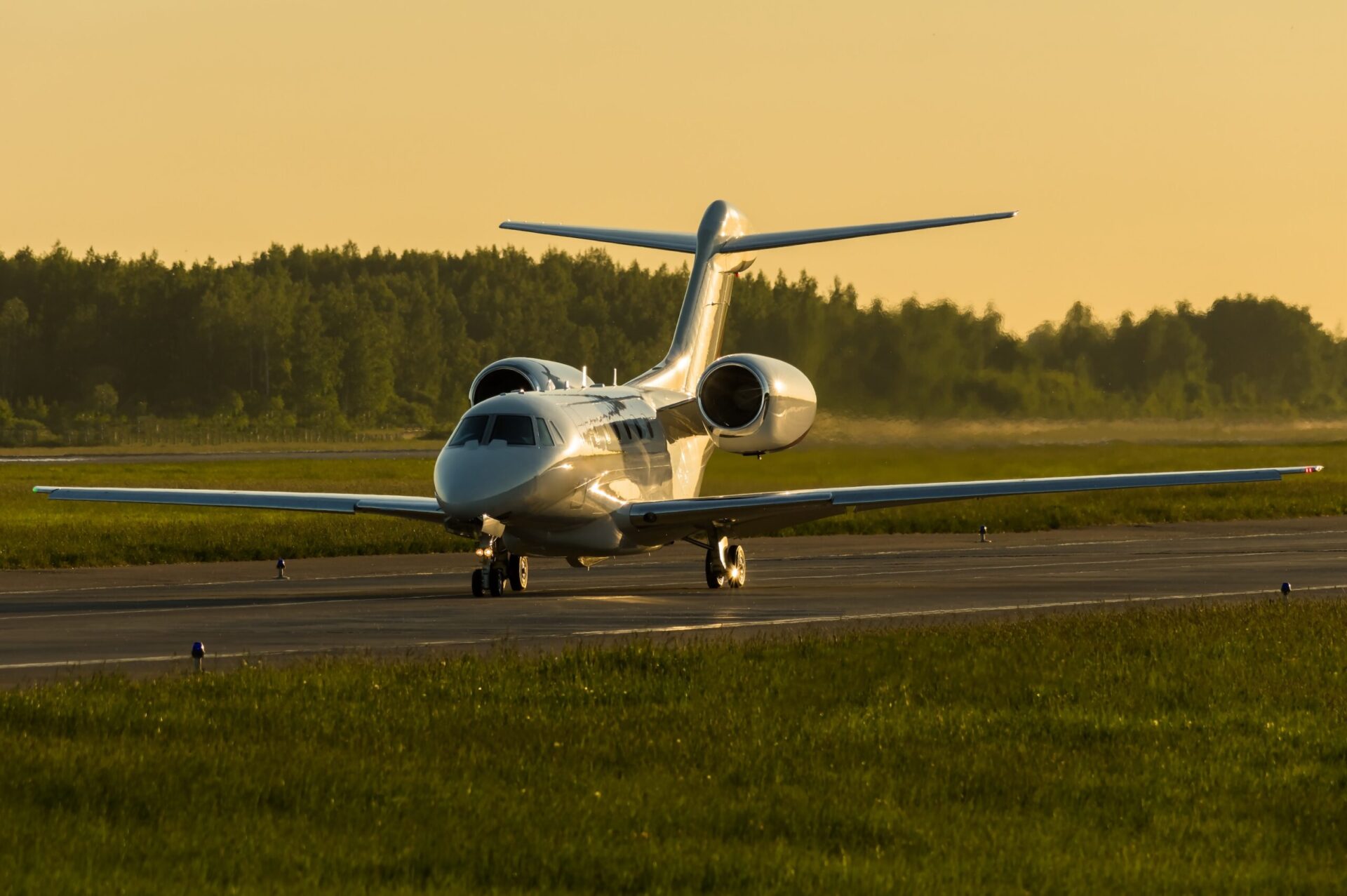 Front view of Cessna Citation X at airport during sunset taxi
