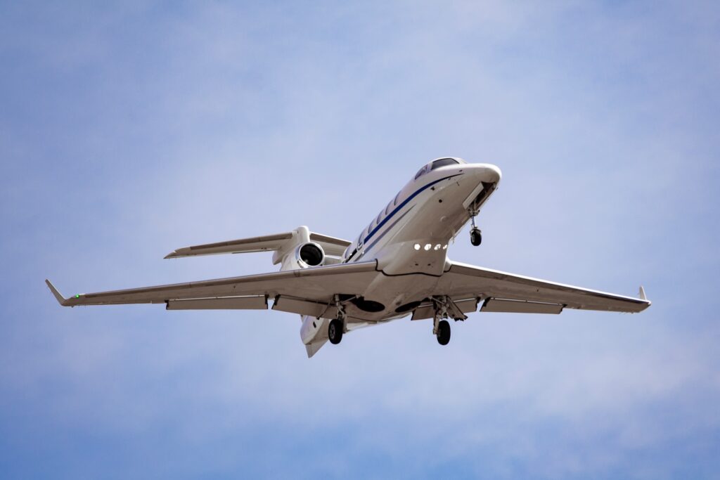 under view of light jet coming in to land with undercarriage down, a risk of Turbulence
