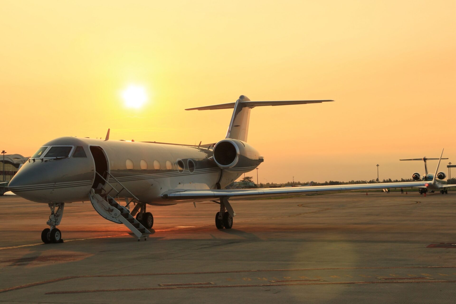 Gulfstream with steps deployed at airport during sunset