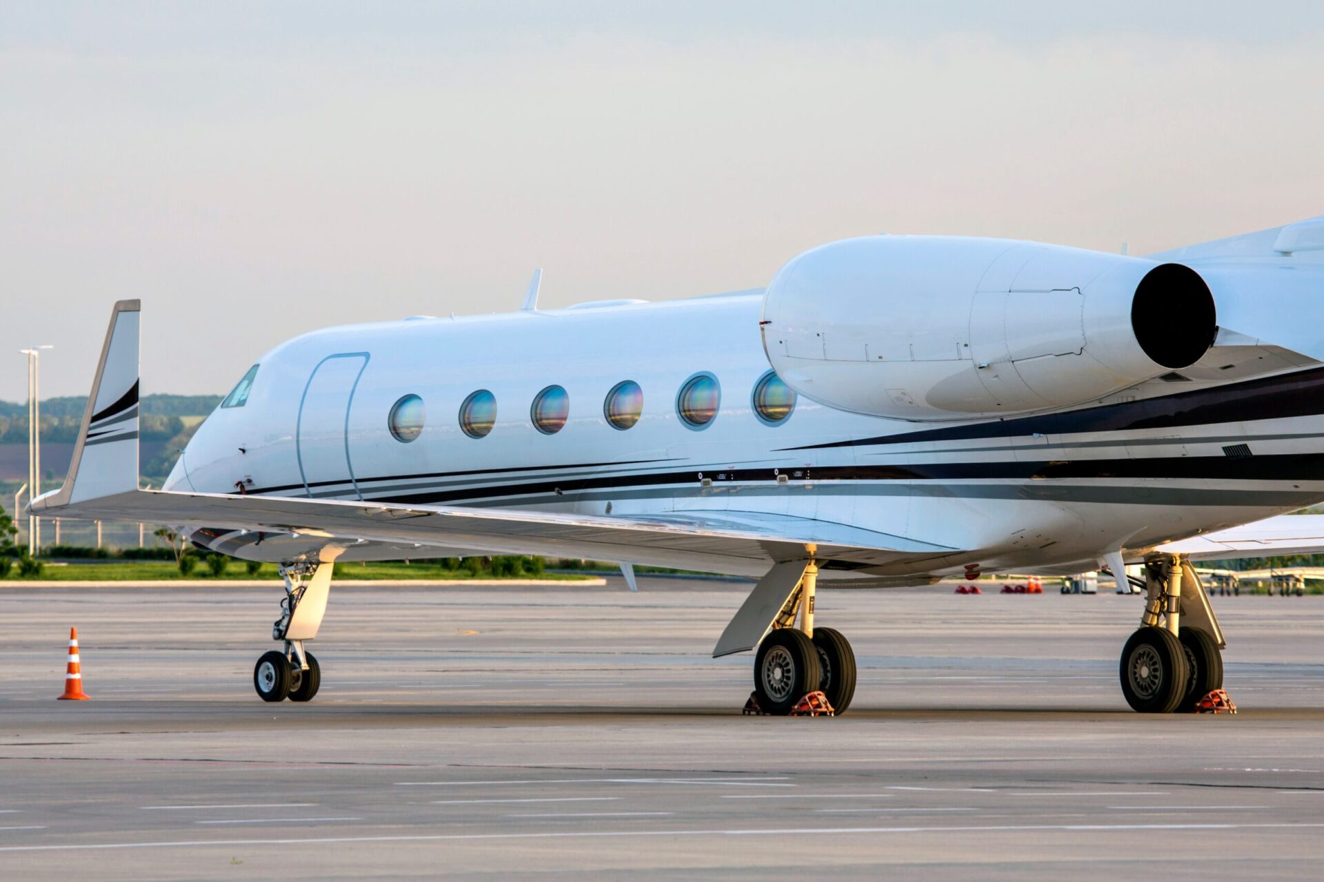 Gulfstream three quarter angle white at airport with sun reflections