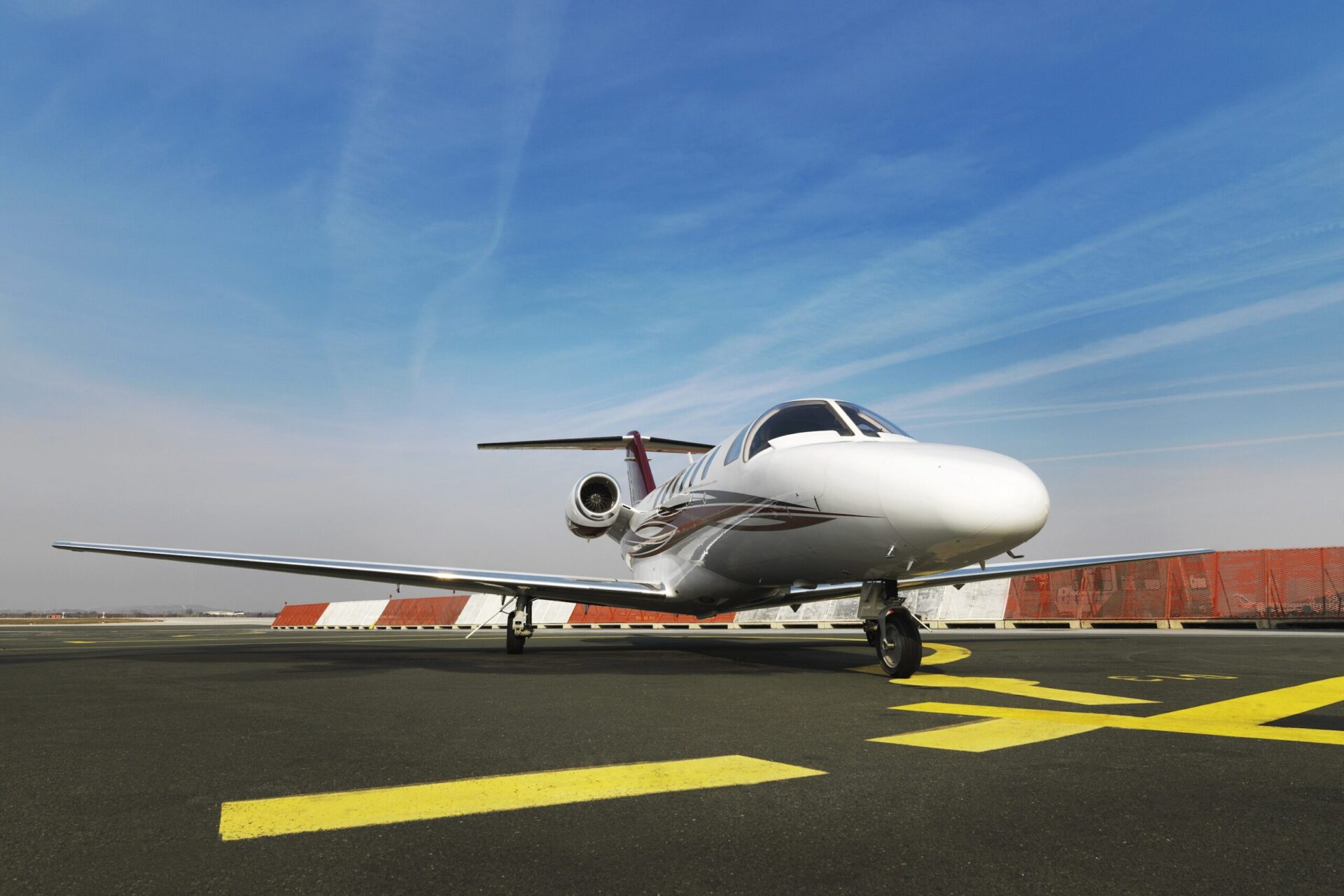 Cessna Citation M2 sat on ground at airport low angle shot nose on