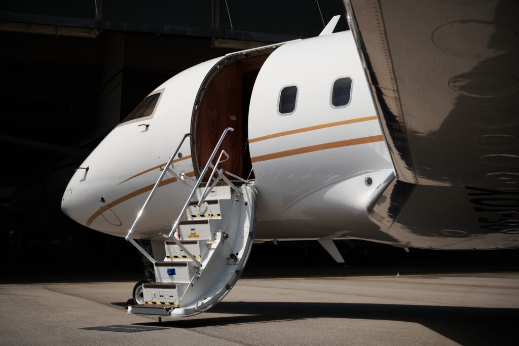 Bombardier Challenger 604 close up exterior night with stairs deployed