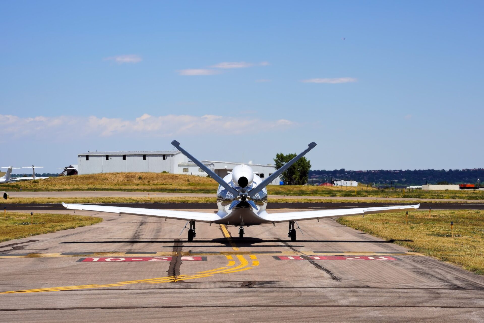 Rear view of Cirrus SF50 vision jet taxiing at airport