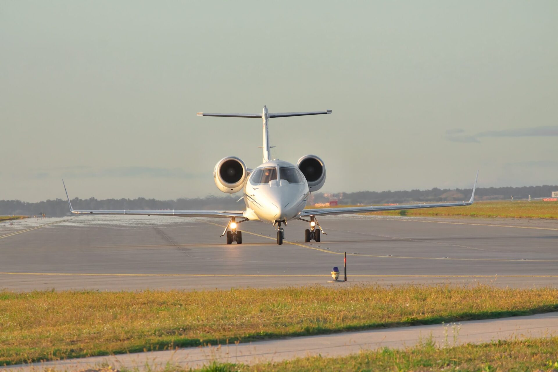 Business jet taxiing along the runway front on