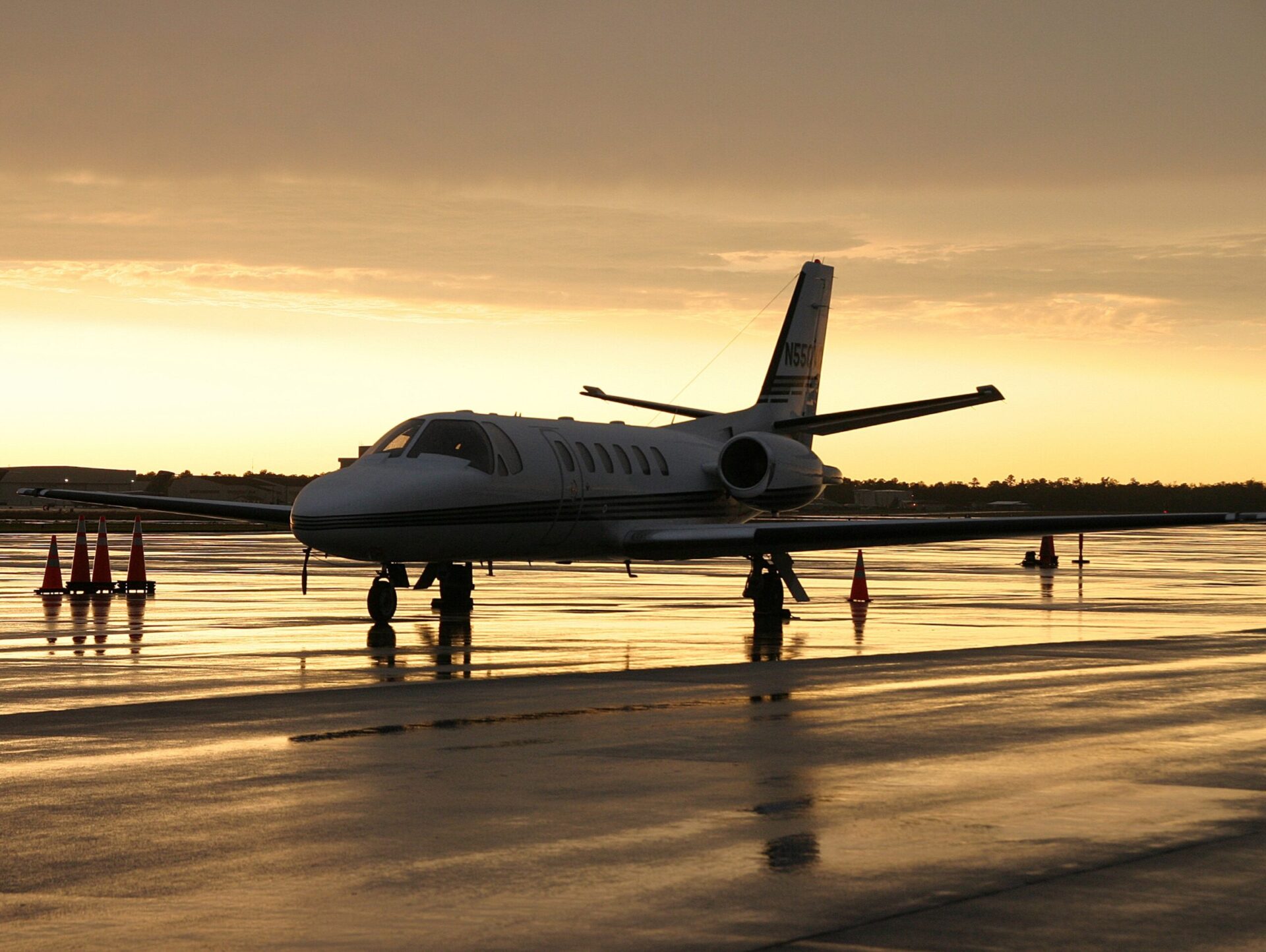 Cessna Citation II parked on stormy ramp with golden sky behind