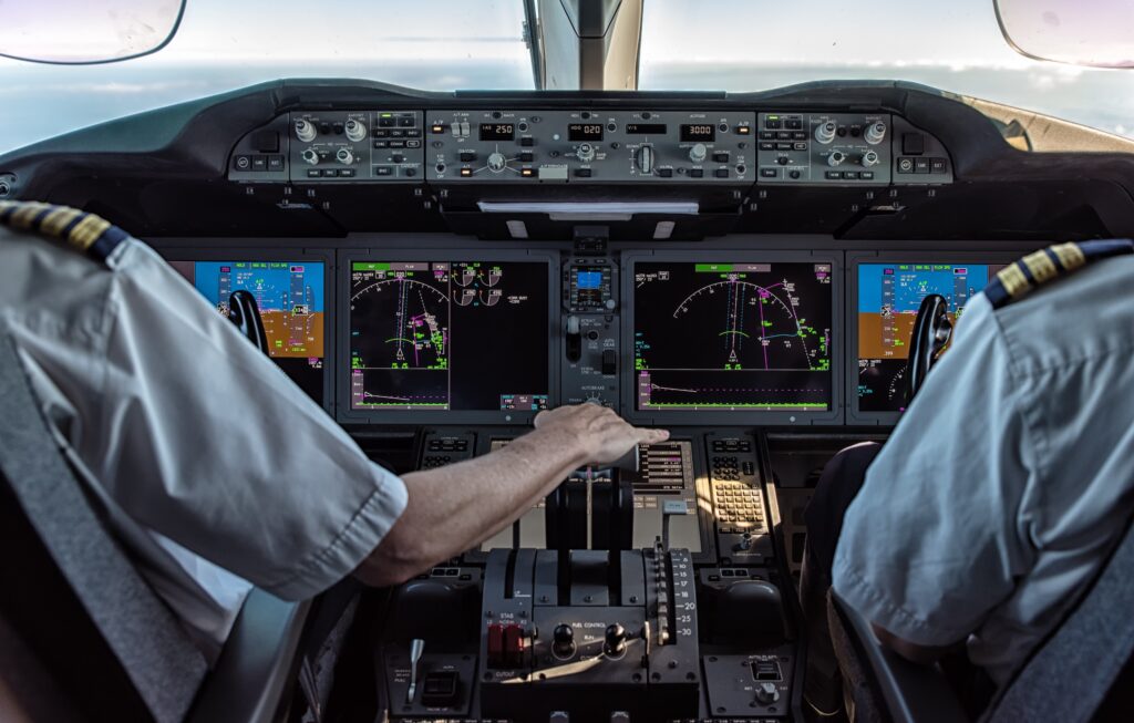 Captain and first office over shoulder shot flying business jet. Choose the right private jet