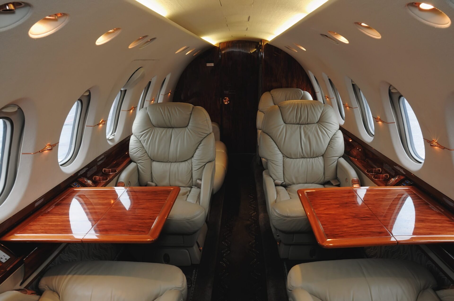 interior of midsize business jet with tables extended