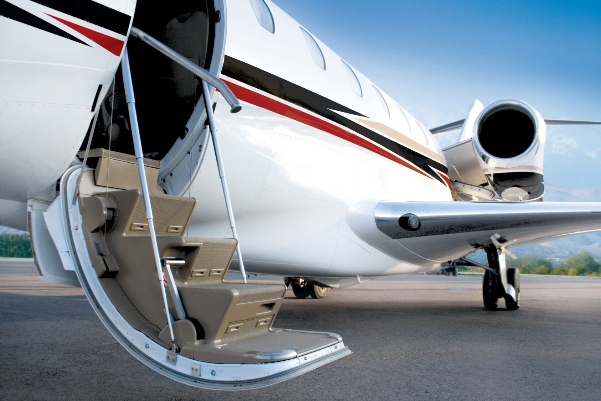 Business private jet with open stairs waiting for passenger, early morning, blue sky. Open door. Ready jet.