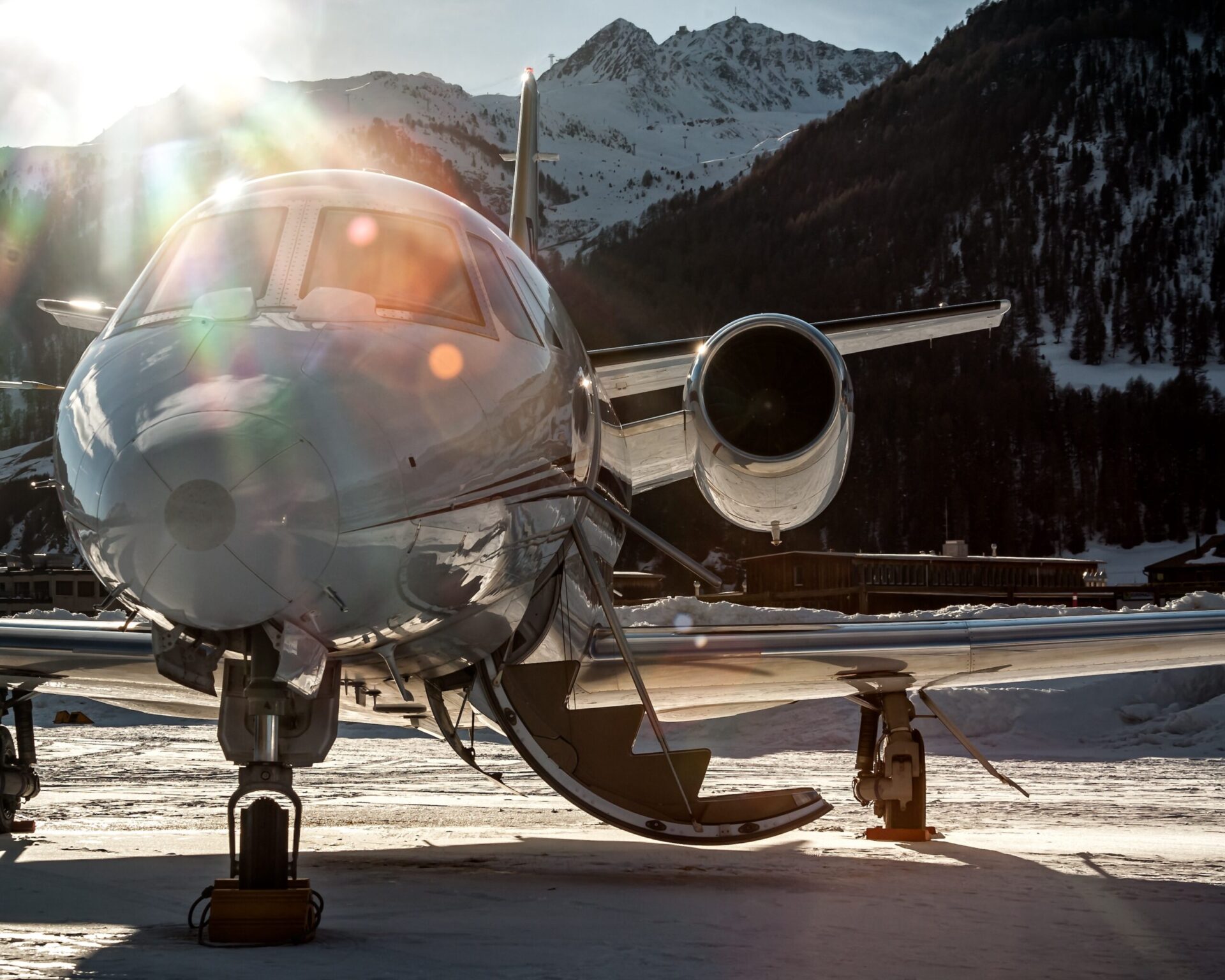 private jet Parked at Samedan Engadin Airport over snow park at the last light of day