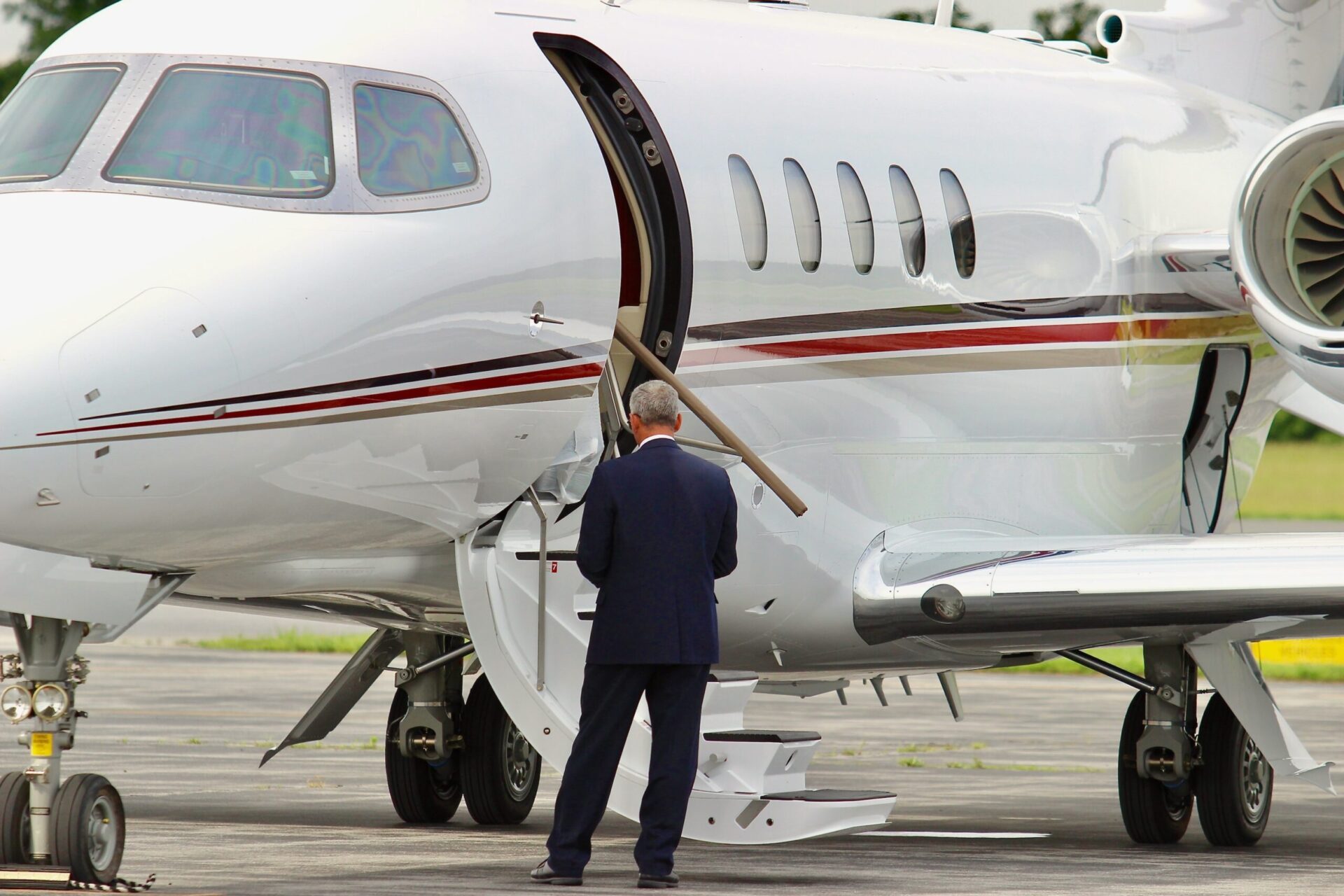 Businessman next to his corporate jet.