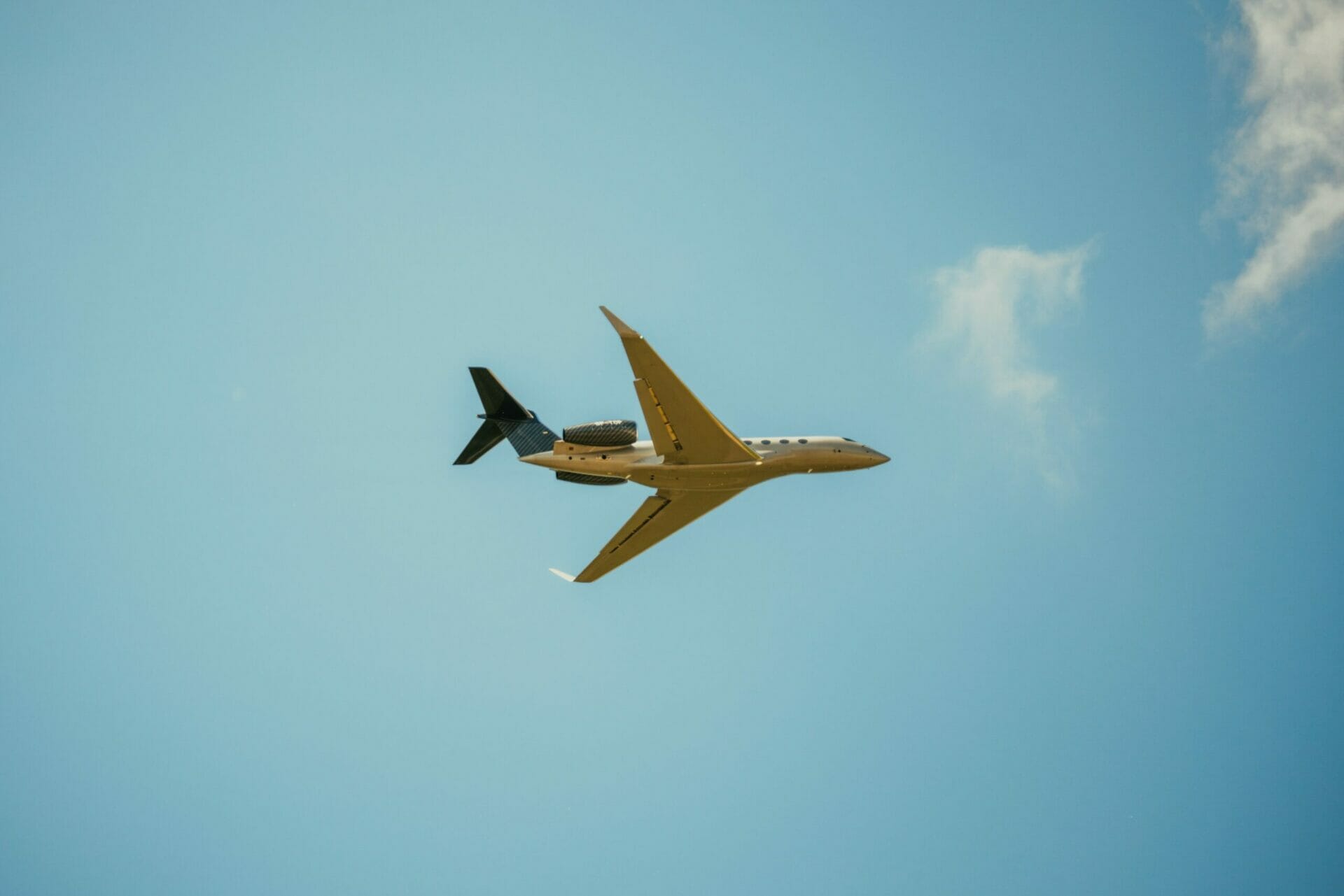 Private jet in the sky flying overhead