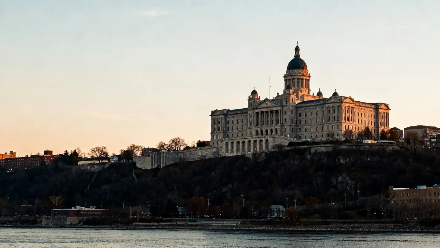 Albany: the Hudson River with a grand stone capitol building on the hill at sunset