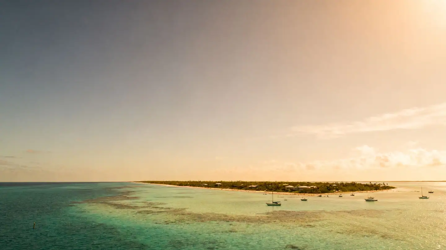Bimini: a narrow island with clear shallow turquoise flats and small boats in golden-hour light
