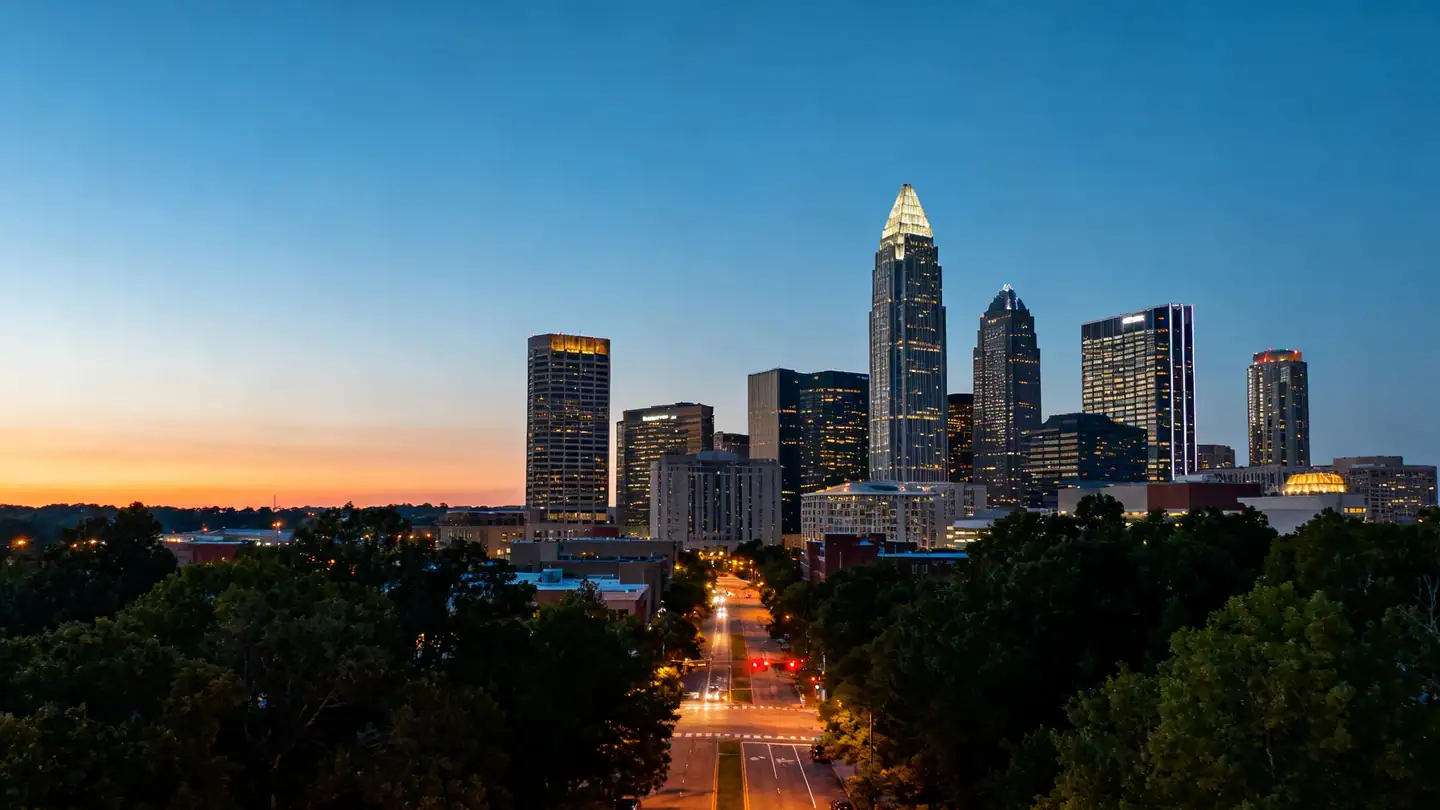 The Charlotte skyline above leafy uptown streets at dusk