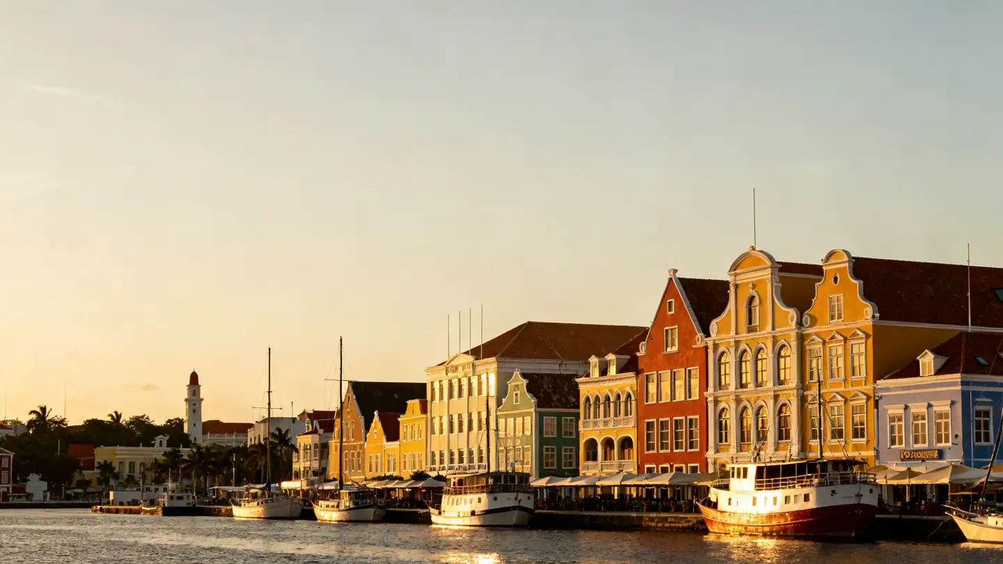 Curaçao: the colorful Dutch colonial waterfront in Willemstad on a harbor channel in golden-hour light