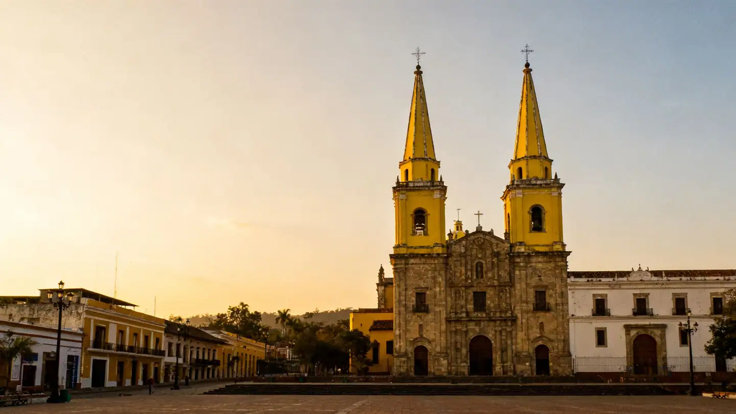 Guadalajara: a colonial cathedral with twin yellow spires above a plaza in golden-hour light