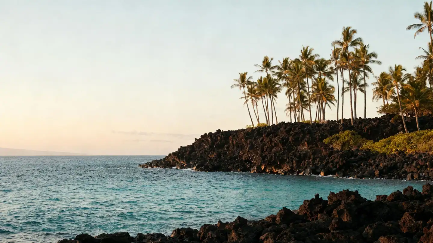 The Kona coast of Hawaii: black lava rock shoreline at sunset