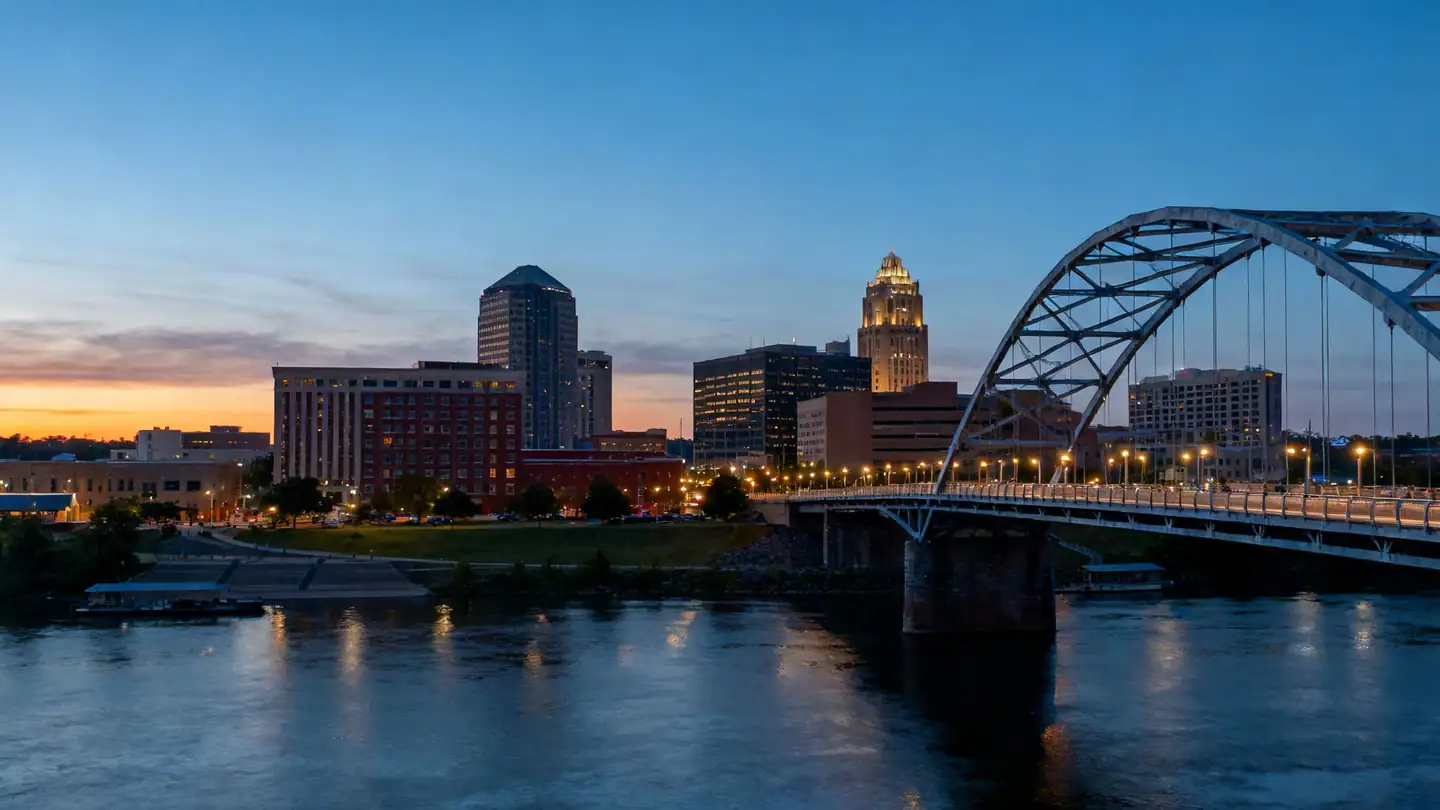 Little Rock: the Arkansas River with a pedestrian bridge and downtown at dusk