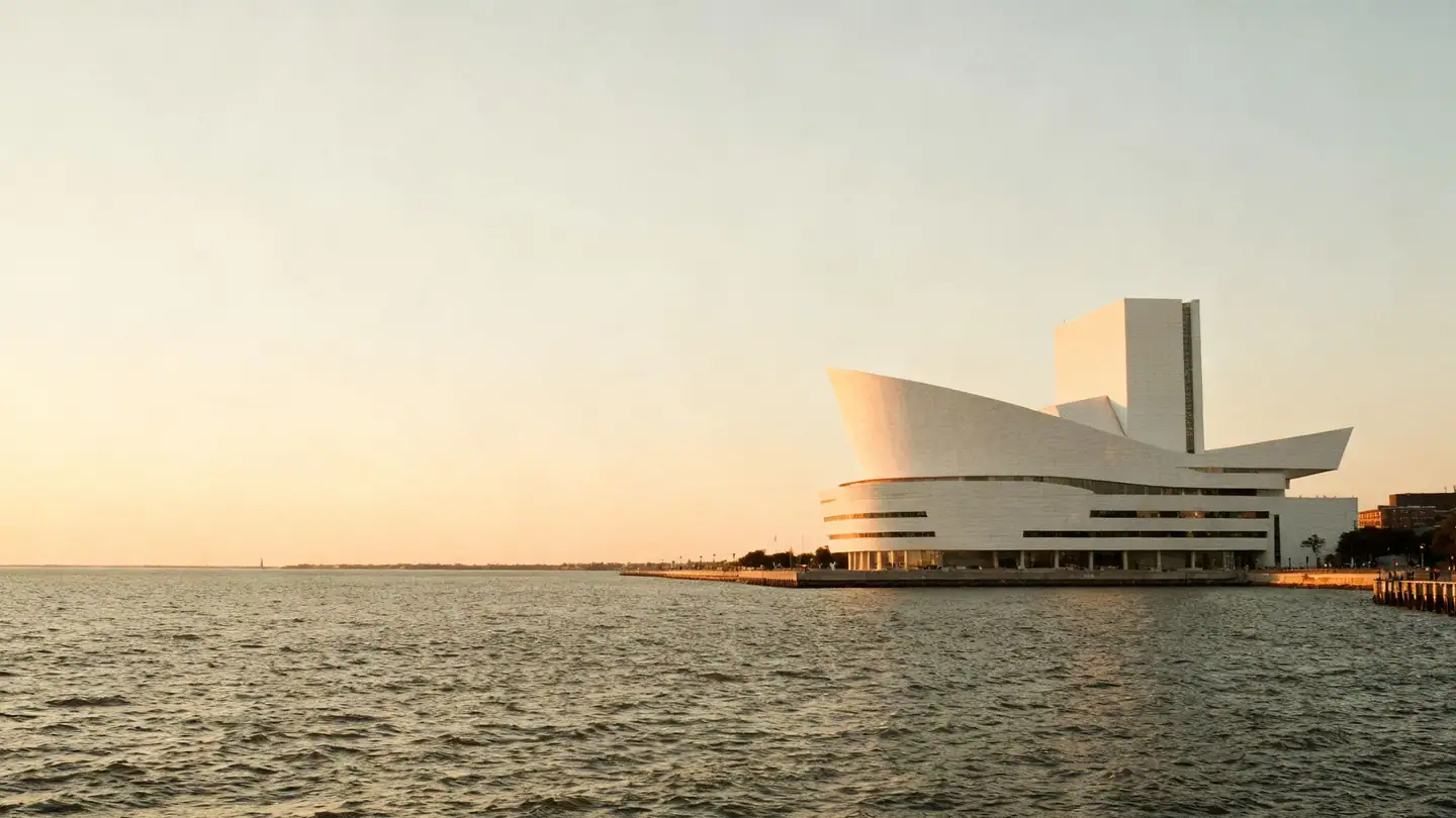 The Milwaukee lakefront with a modern white winged museum building and Lake Michigan at sunset
